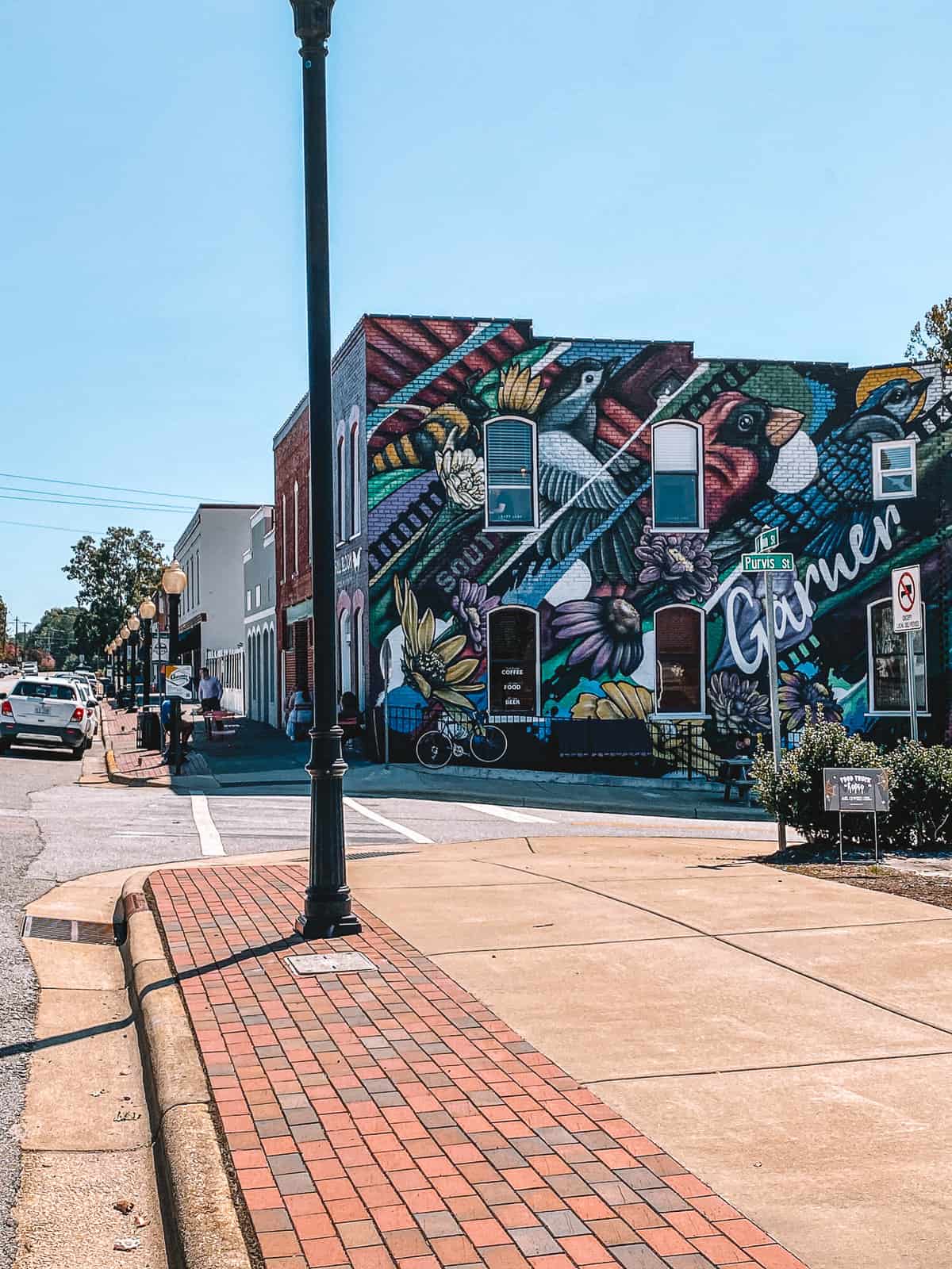 an artistic mural on the side of a brick building