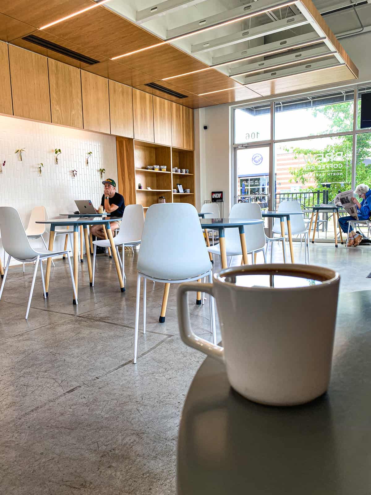 Coffee inside BREW coffee bar in Raleigh NC, a modern and white coffee shop.