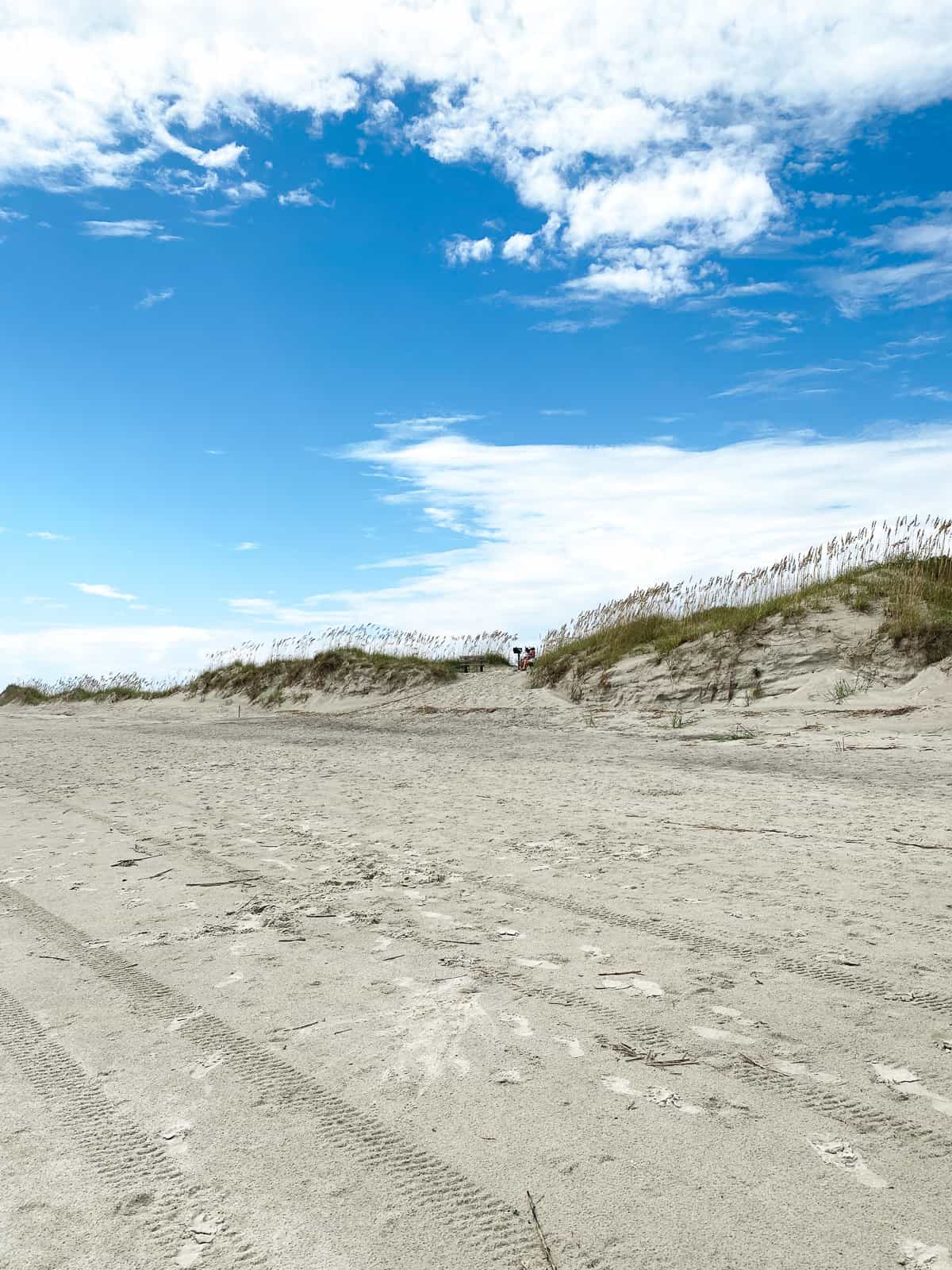 Beautiful sand dunes with a bright blue sky and clouds at Bird Island North Carolina