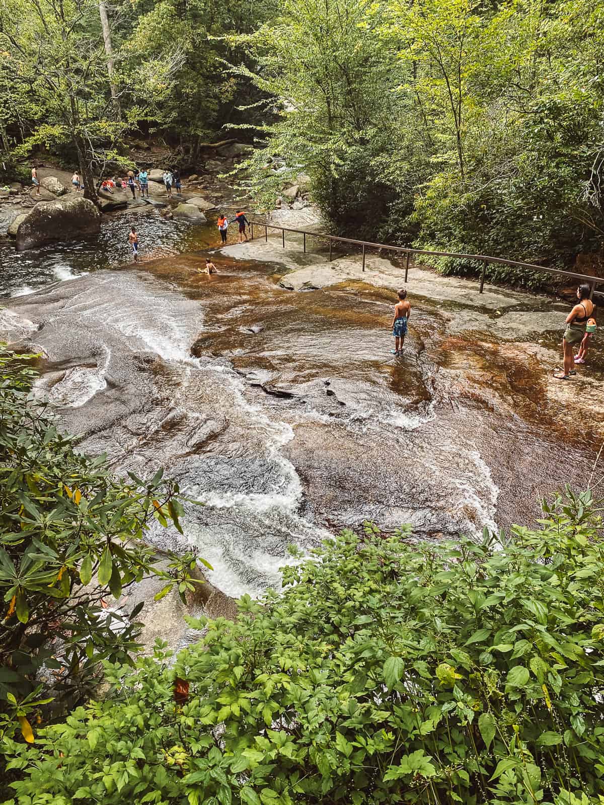Children sliding down Sliding Rock Falls in Pisgah National Forest