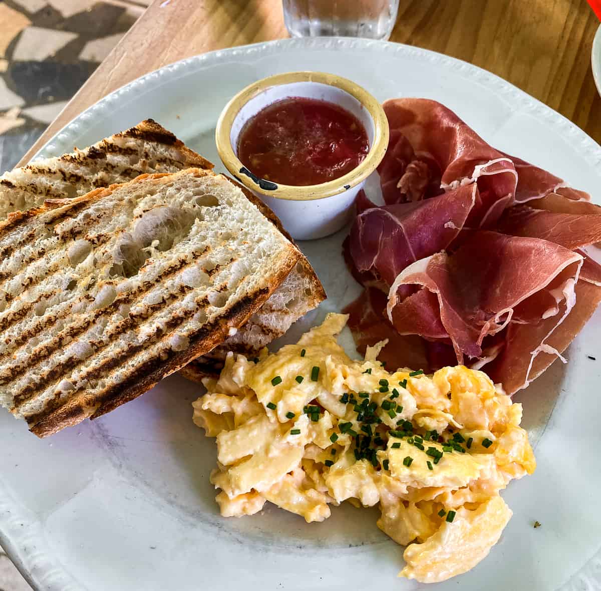 A plate with ham, eggs and toast