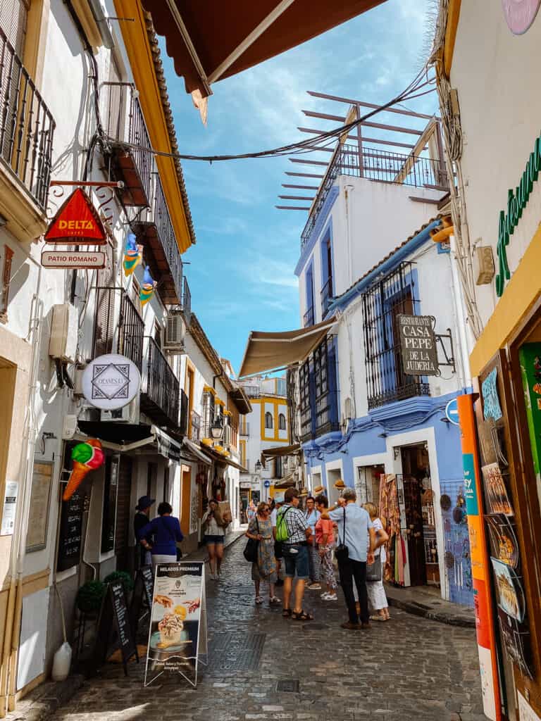 a street with white washed houses and colorful windows