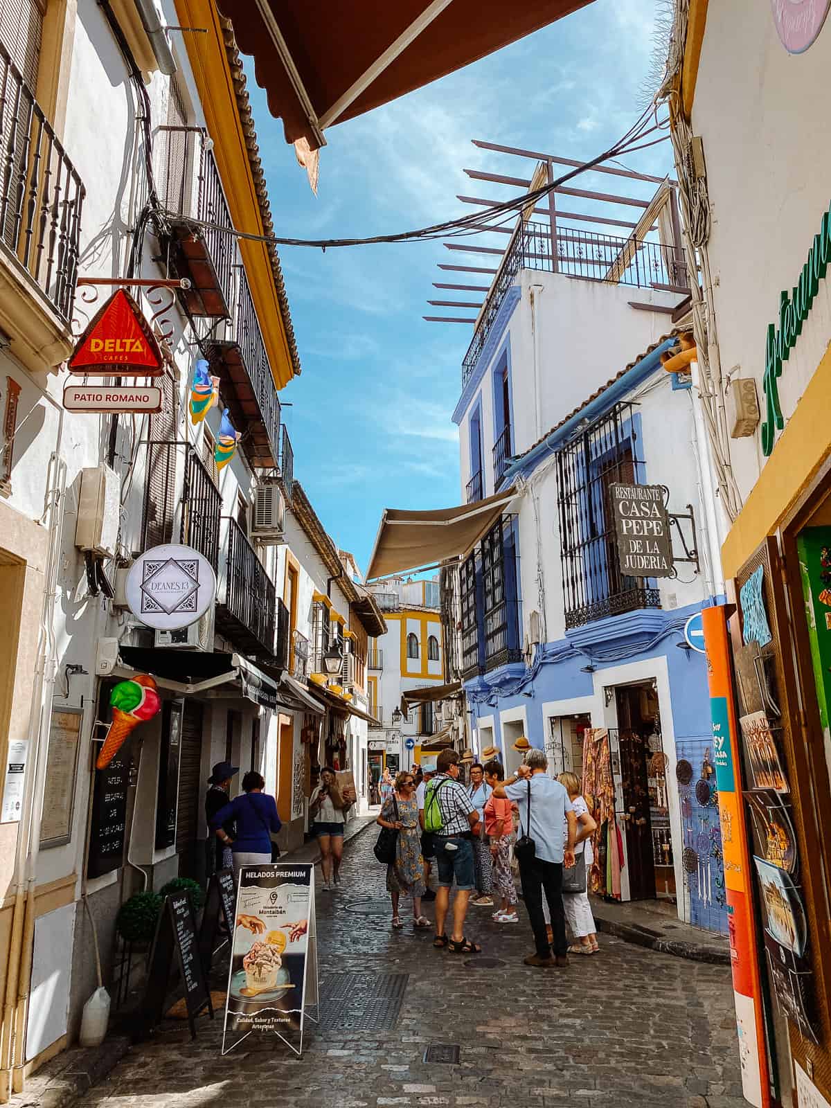 a street with white washed houses and colorful windows