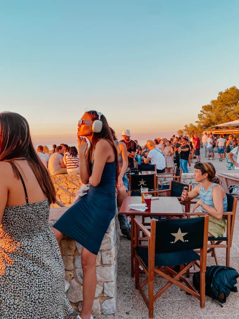 A large number of tourists watching the sunset