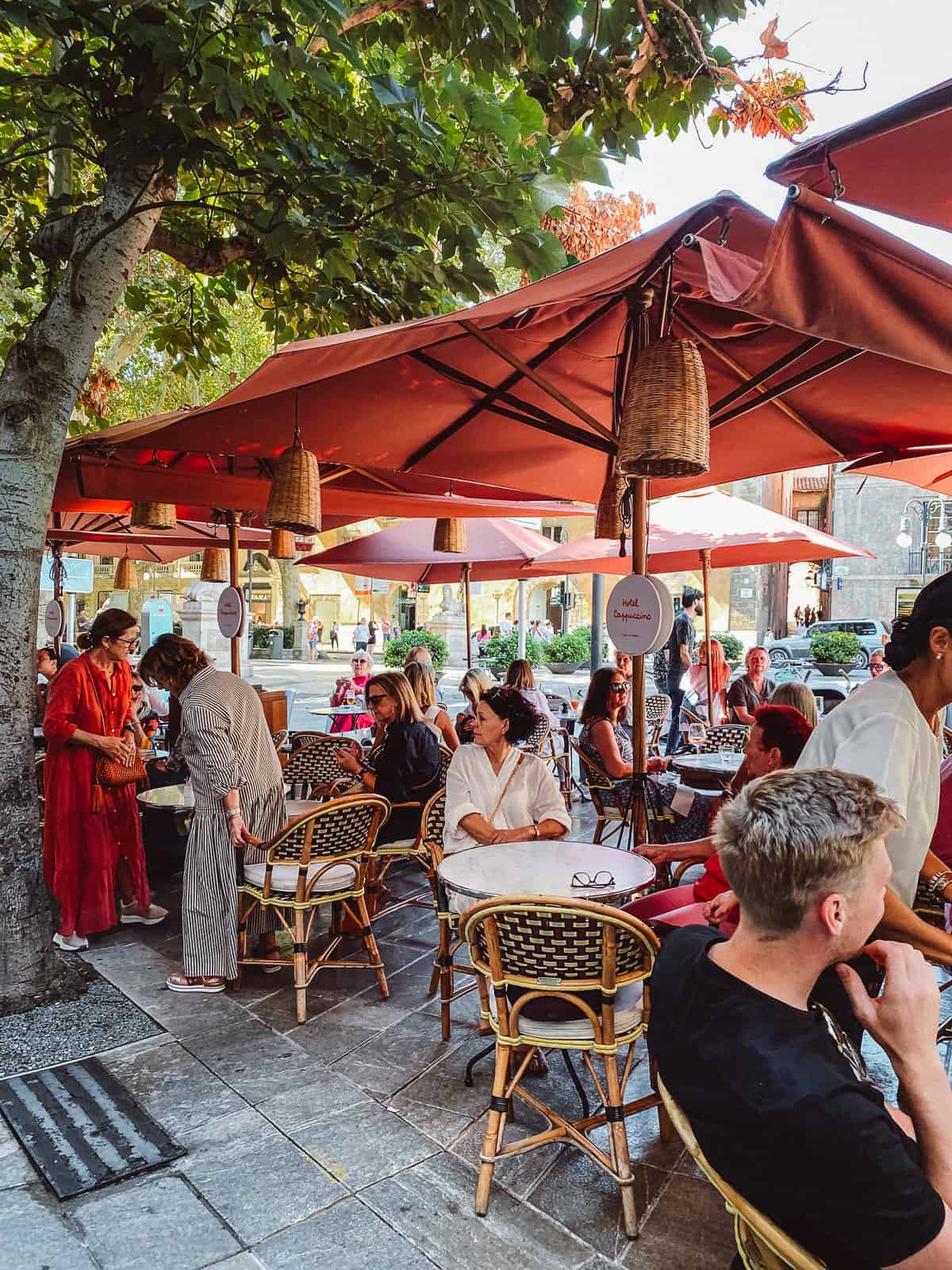 some people sitting on restaurants outside eating lunch