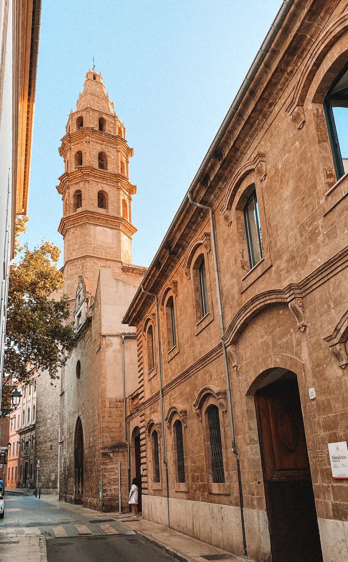a stone church spire on a cobblestone street
