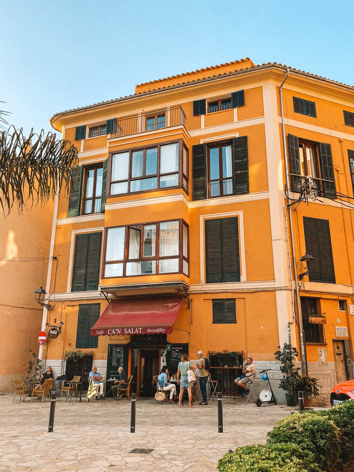 an orange gelato shop on a cobblestone street