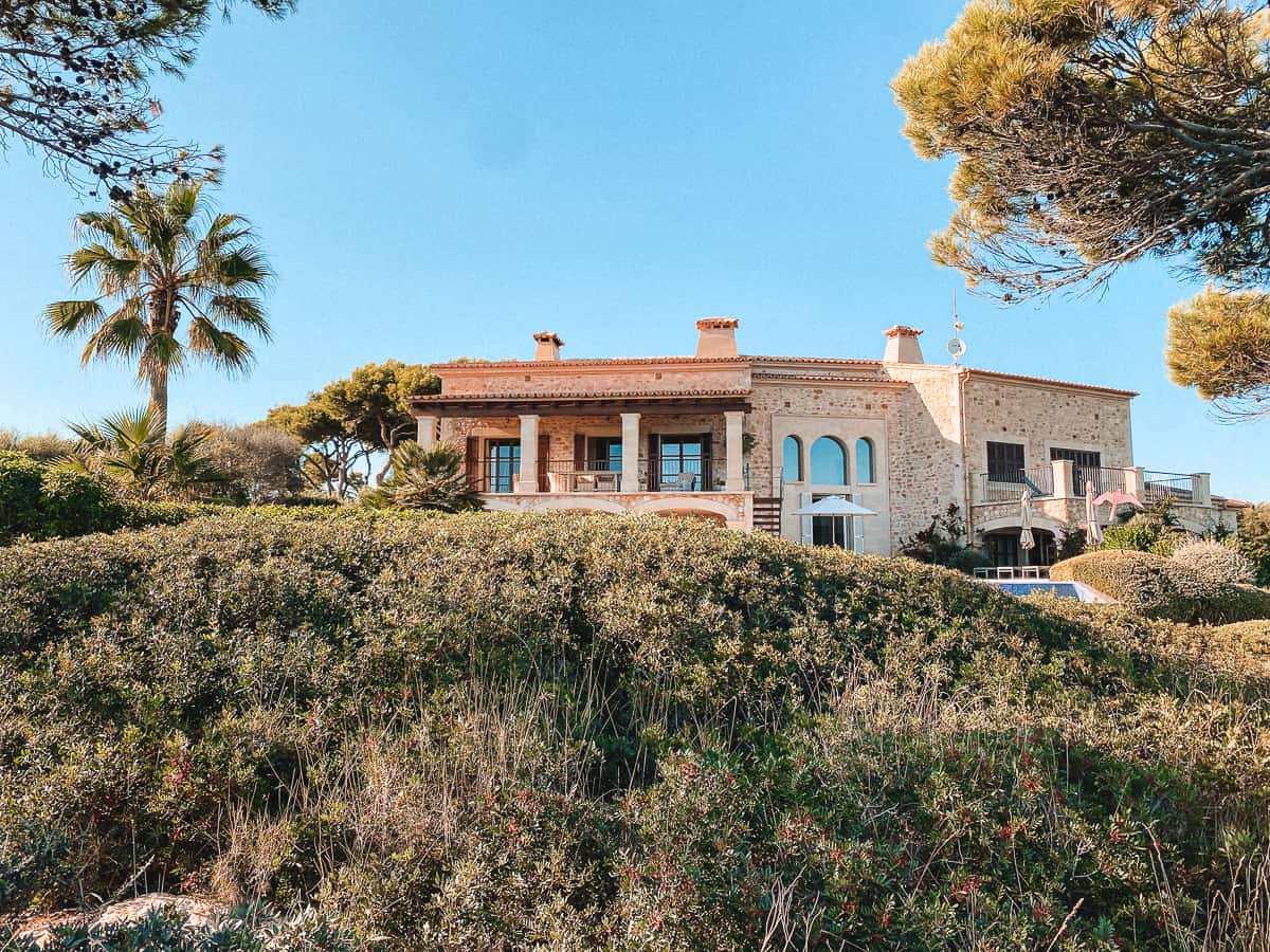 An old stone farmhouse in the middle of rolling green hills
