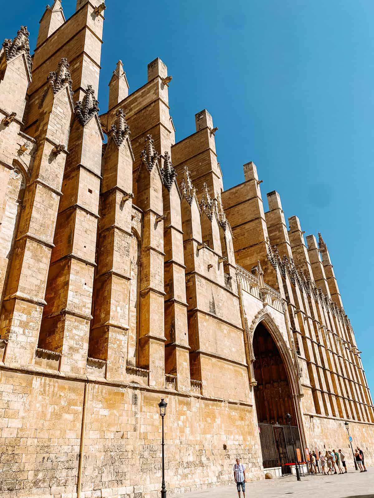 A large brownstone cathedral with a bright blue sky