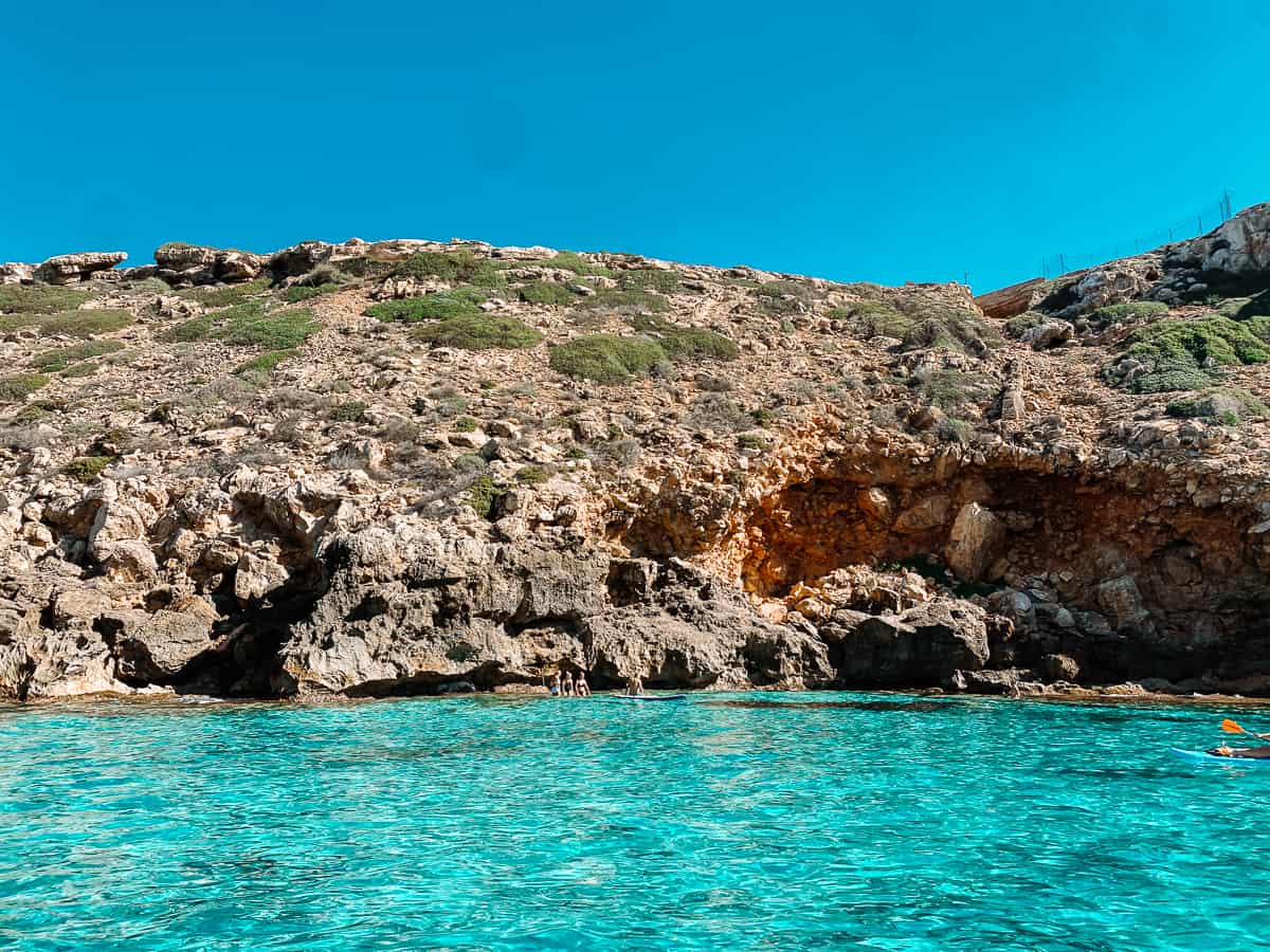 The Mediterranean Sea in Llucmajor, Mallorca with a cliff in the background