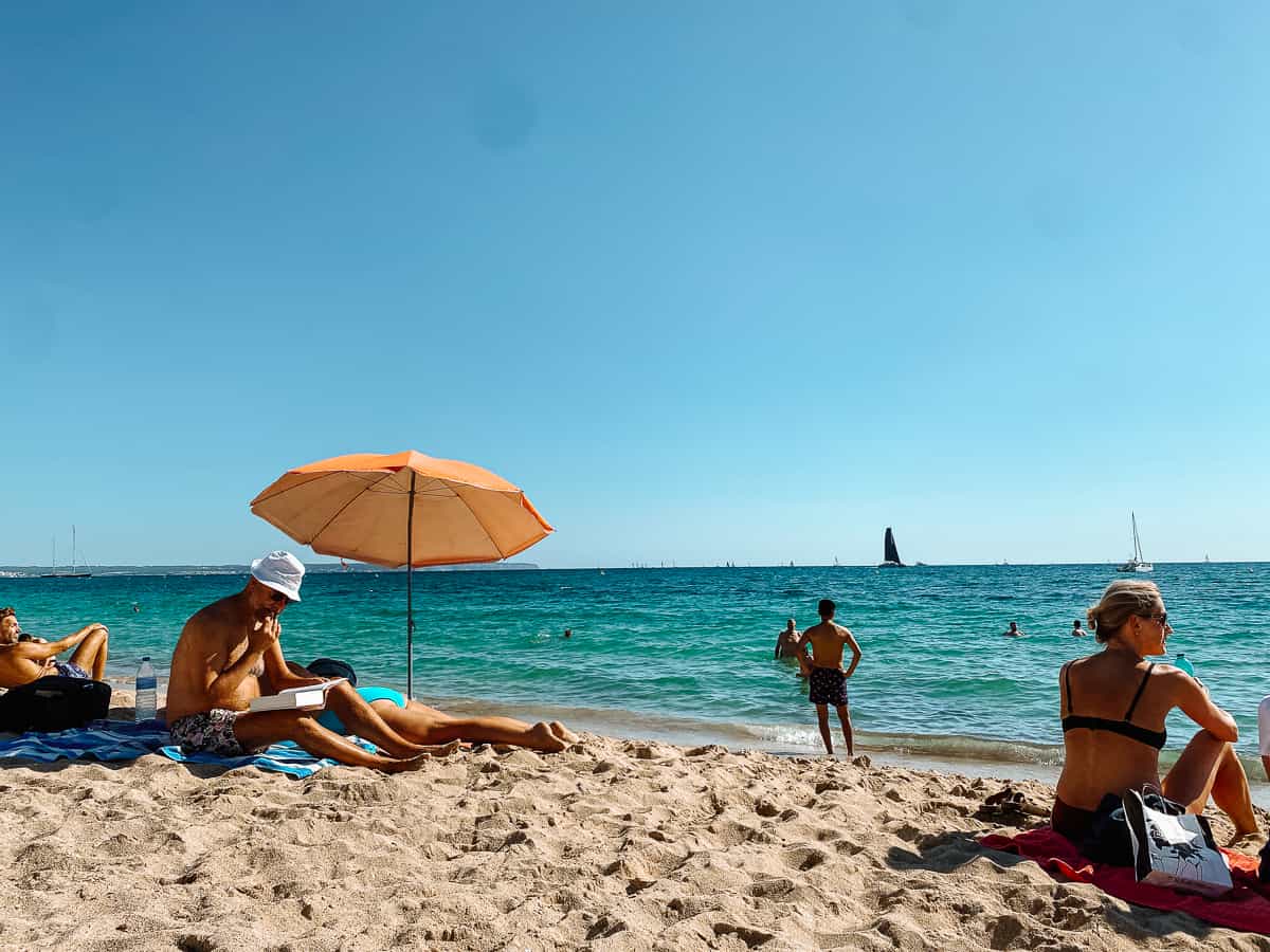 a white sandy beach on the Mediterranean with bright blue sky