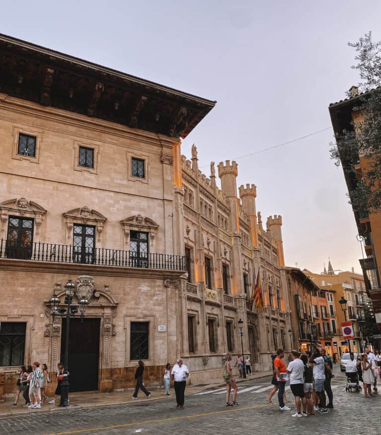 a beautiful brown building at sunset on a cobblestone street