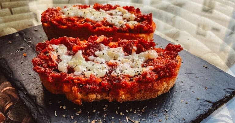 toasted bread with sobrasada sausage on top sitting on a granite plate