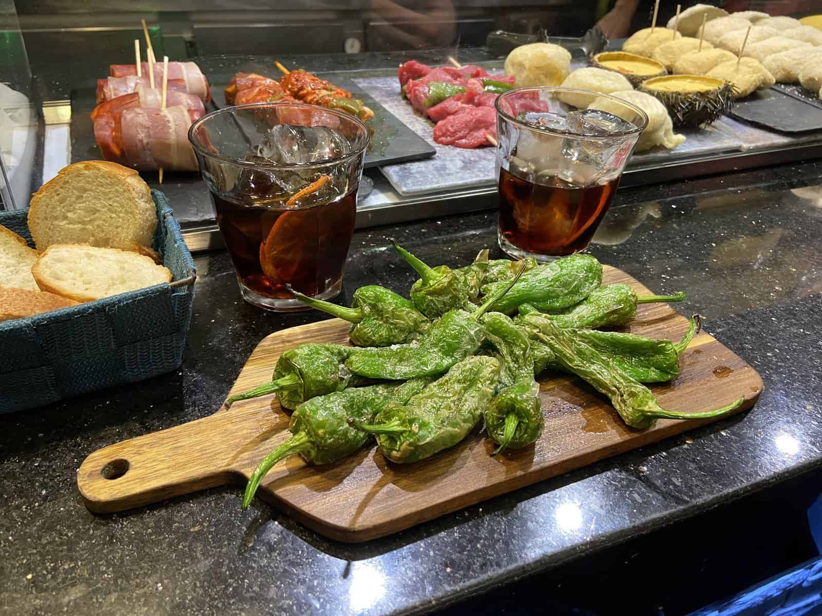 Plates of Spanish tapas with glasses of Spanish vermouth