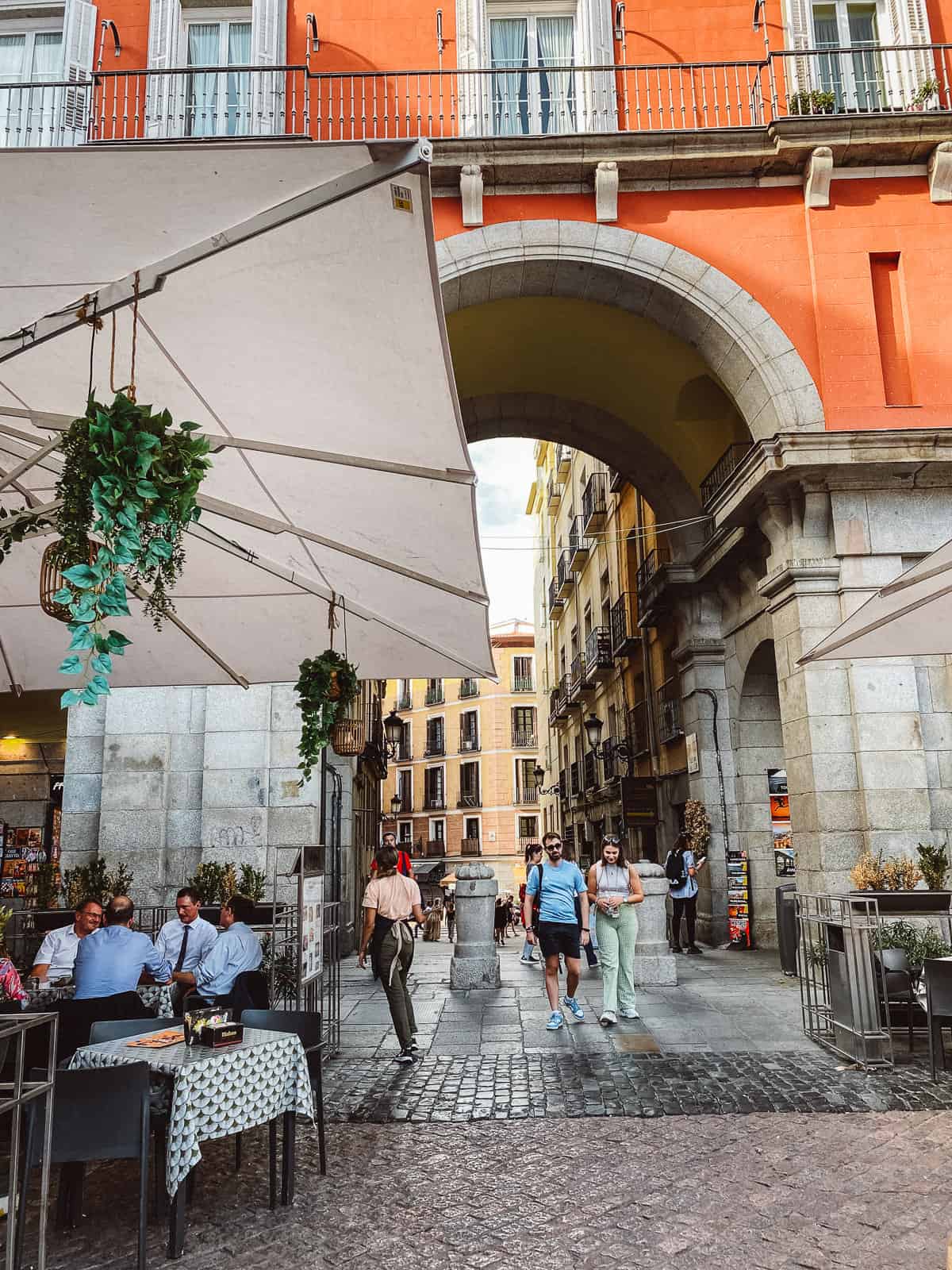People sitting and enjoying a drink in plaza mayor in Madrid