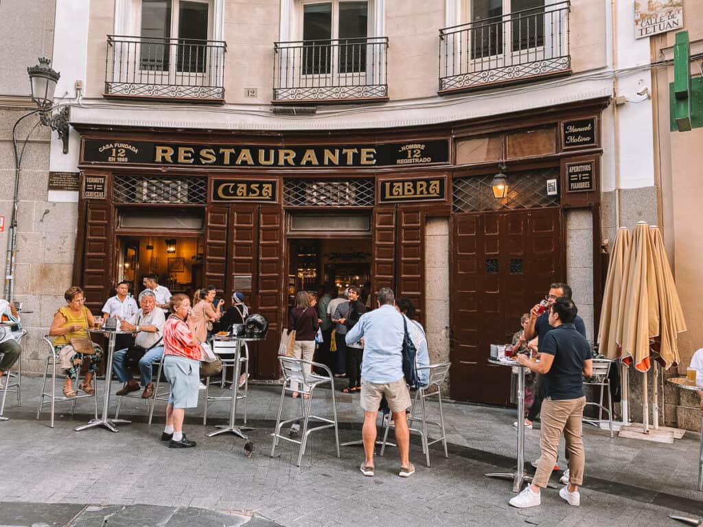People standing outside of a tapas bar in Madrid