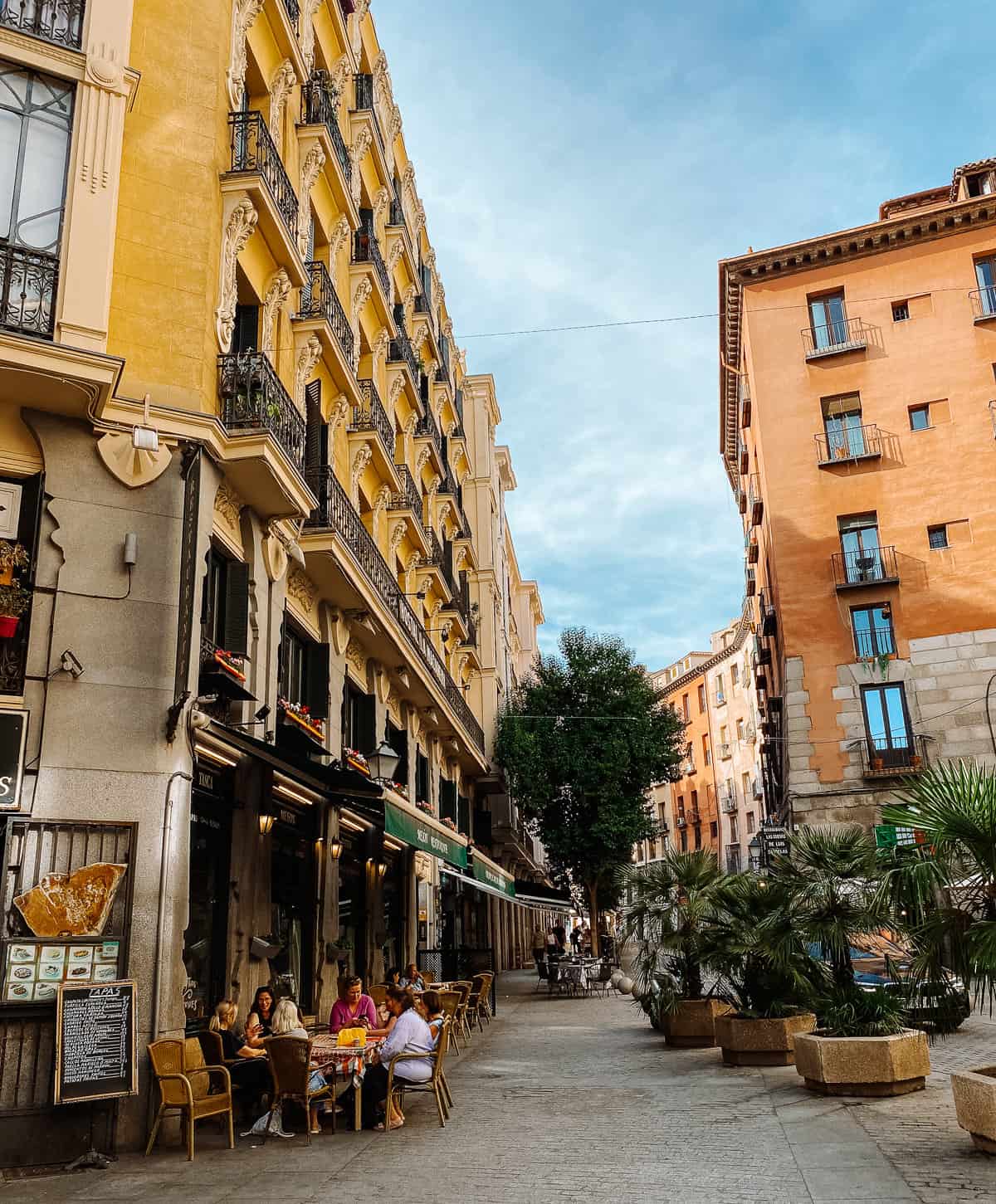 People relaxing at a cafe on a street in Madrid