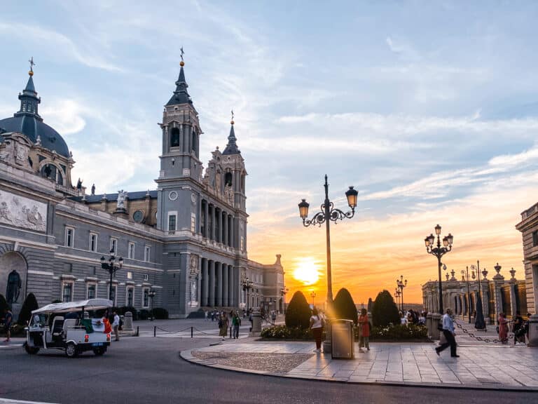 The Almudena Cathedral in Madrid at sunrise with an orange sky