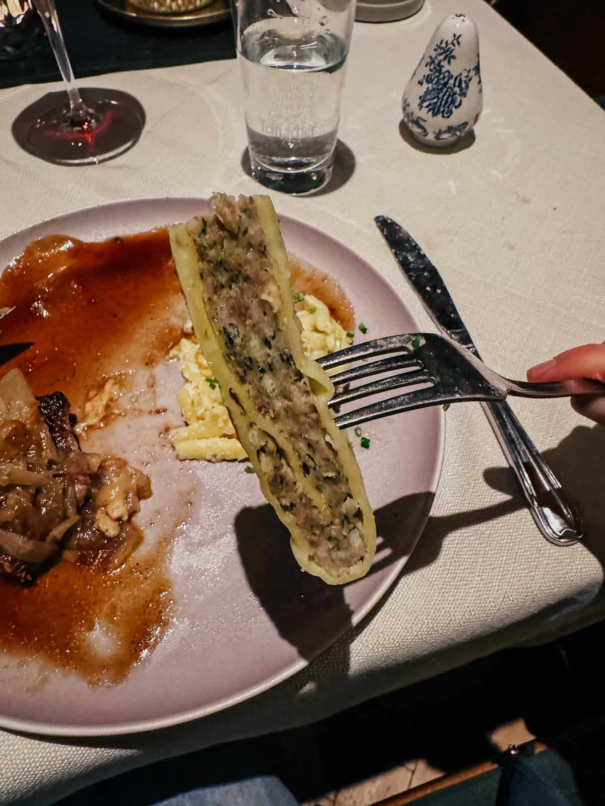 a dish typical at such markets, possibly containing meat and served with a sauce, illustrating the local cuisine enjoyed during the market festivities.
