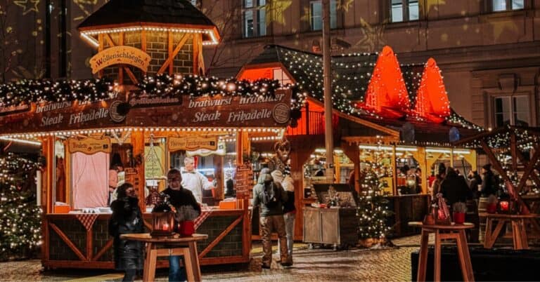 A bustling Christmas market in berlin with a wooden Christmas pyramid