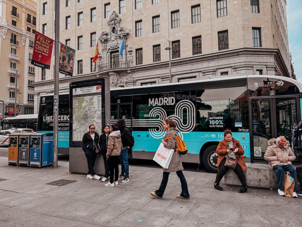 a blue and black bus in Madrid that says Madrid 30 on the outside