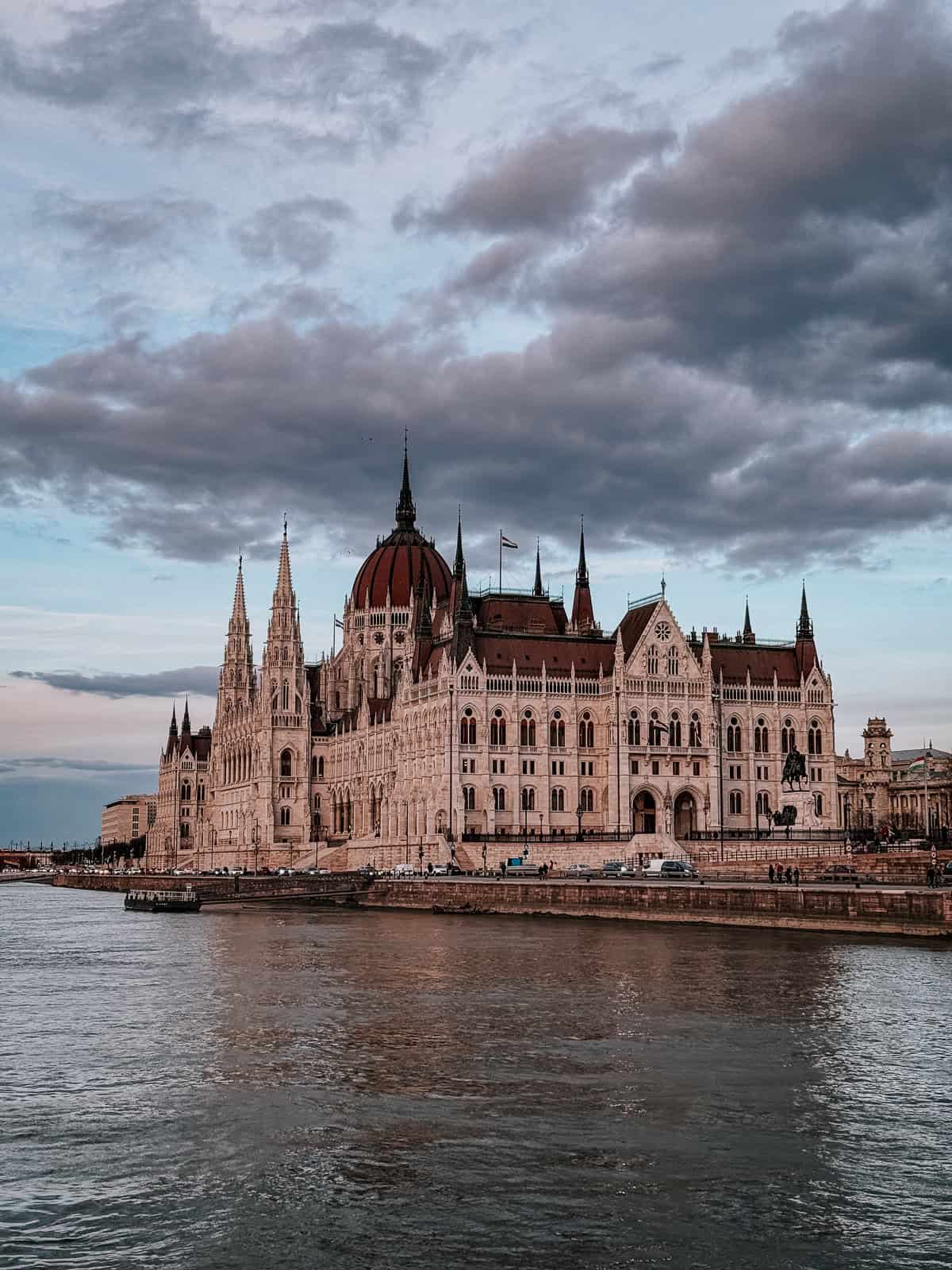 Chimney cakes being baked on wooden spits in a traditional oven, with the golden-brown cakes ready to be served.