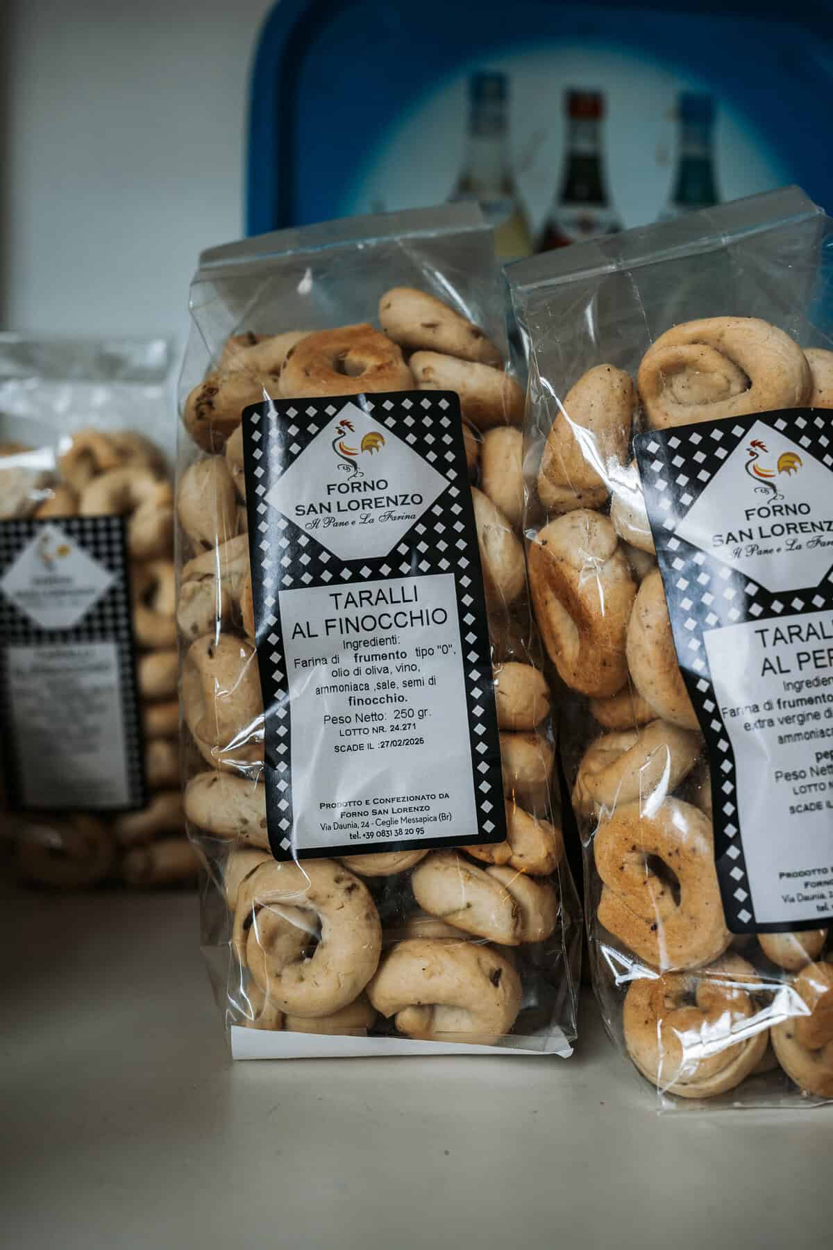 Close-up of packaged taralli al finocchio (fennel-flavored Italian crackers) from Forno San Lorenzo, with a label listing ingredients and bakery details.