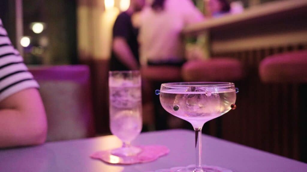 a polka dot cocktail glass on the table of a retro bar