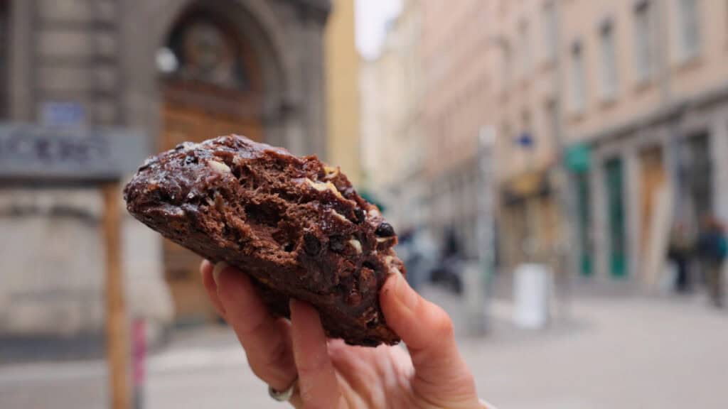 Thick slice of chocolate bread from Antoinette Pain & Brioche in Lyon, with a rich, airy crumb and melted chocolate inside