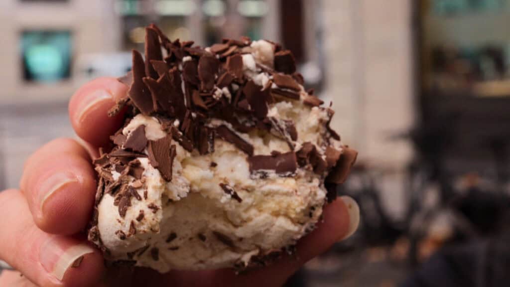Classic merveilleux dessert from Aux Merveilleux de Fred in Lyon, topped with whipped cream and dark chocolate shavings