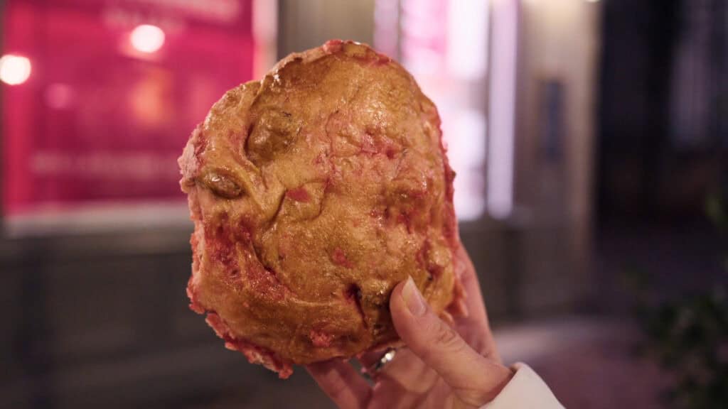 Traditional Lyon praline brioche with a pink sugar and nut filling, photographed fresh from a local bakery