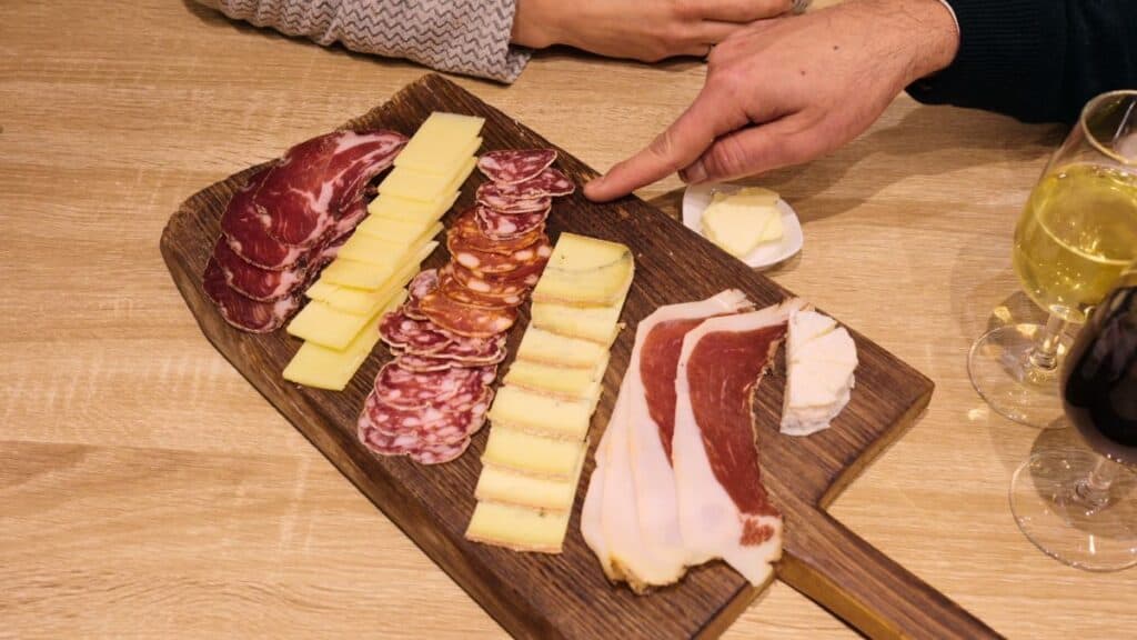 Traditional Lyon charcuterie board with rosette sausage, cured meats, and local cheeses